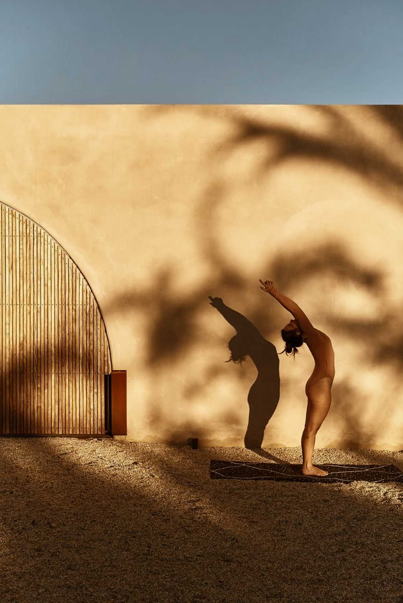 A person practising yoga in warm sunlight