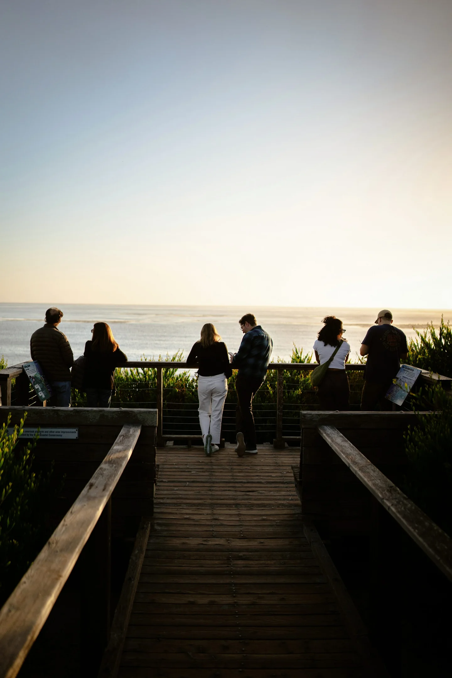 A group facing the ocean