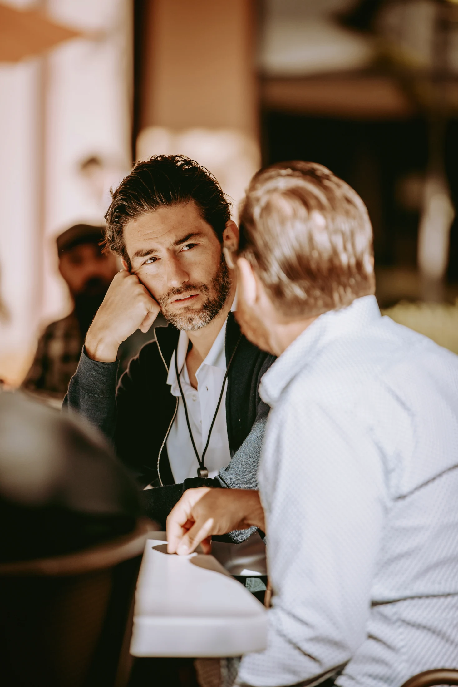 Two people talk in a professional setting