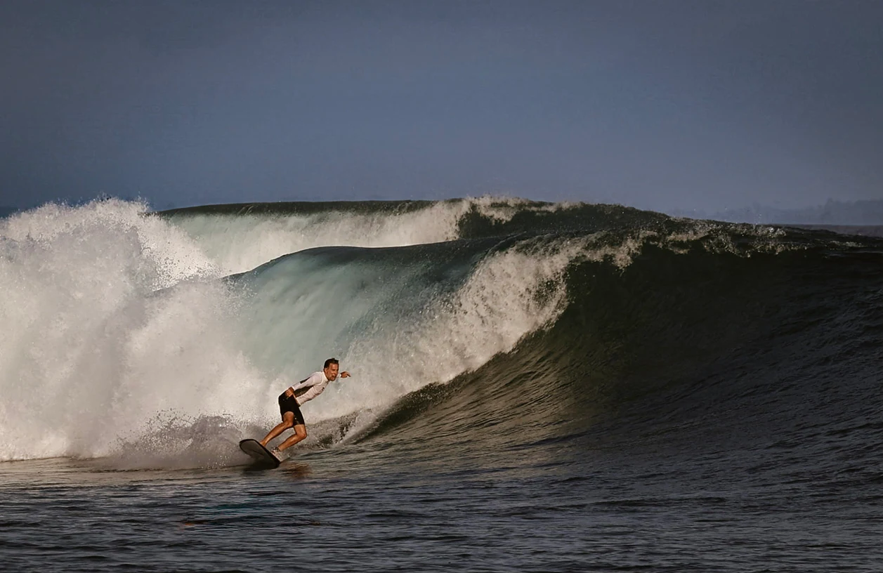 Vincent Luna surfing a wave in the Mentawai Islands